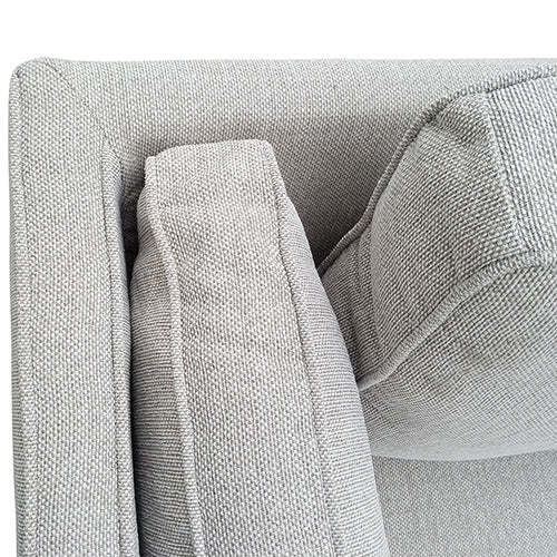 Beige fabric sofa corner detail with stitched armrest and seat seam