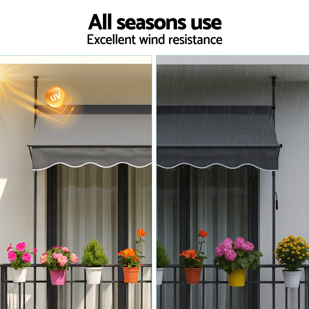 Grey window awning with scalloped valance on pivot arms, water-resistant fabric