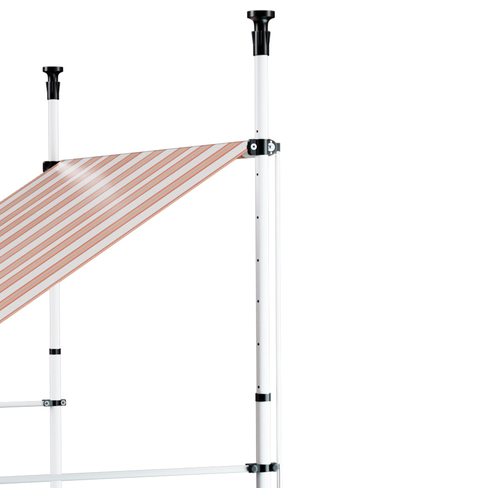 Outdoor awning arm and white support posts with striped canopy fabric