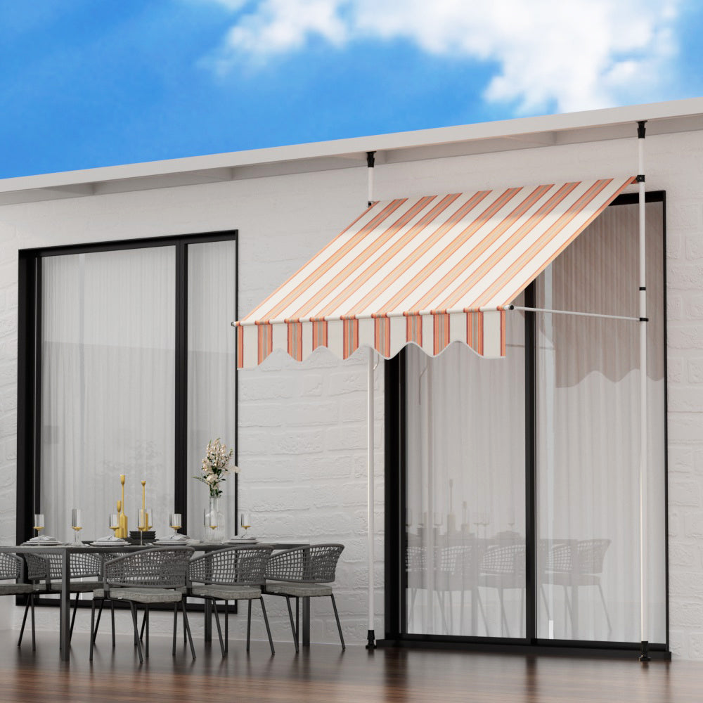 Outdoor awning with striped beige-and-brown canopy and scalloped valance on white frame