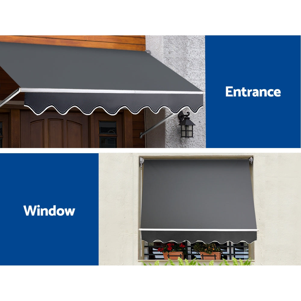 Outdoor window awning installed over a window opening with dark gray canopy and scalloped edge