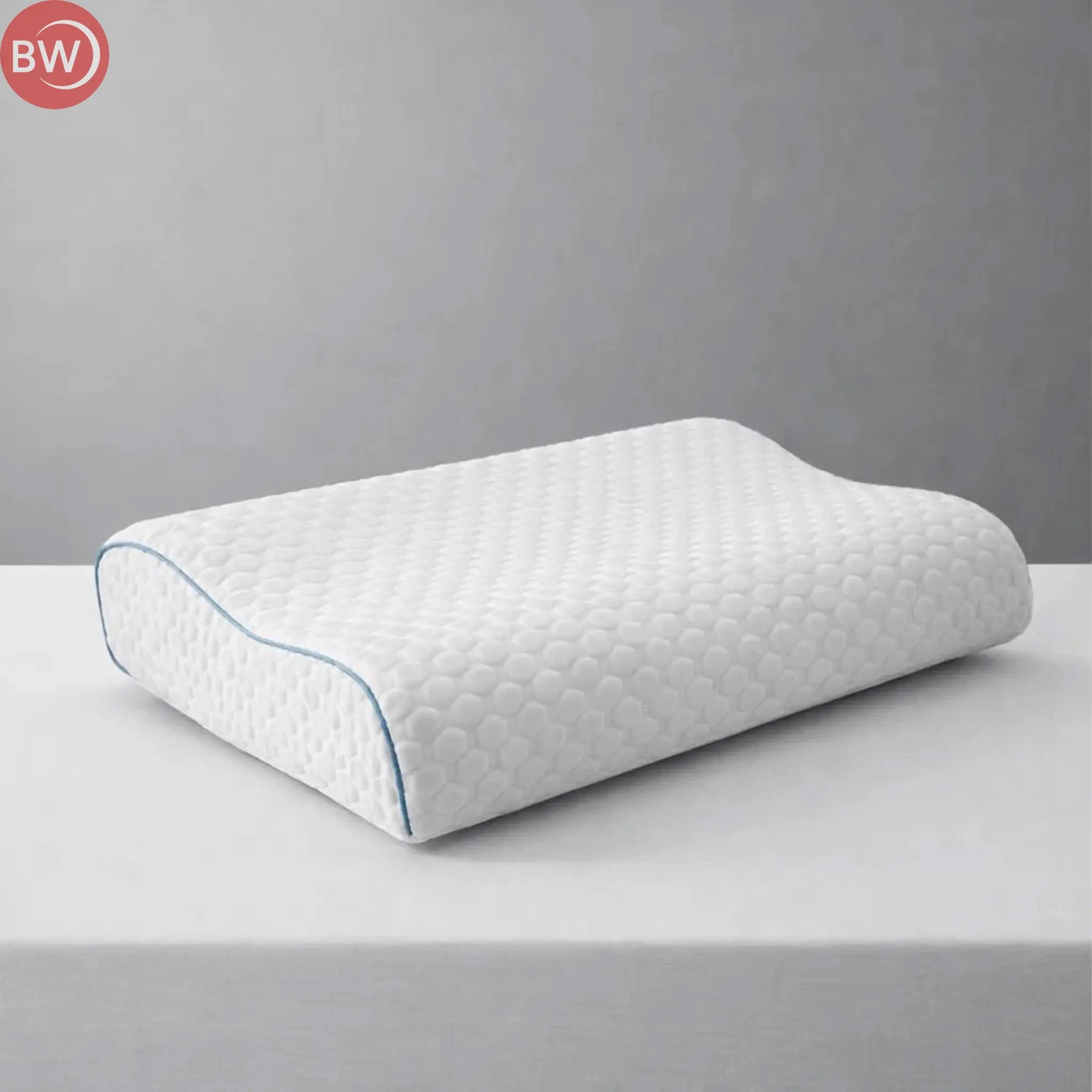 White contoured cooling pillow with blue edge piping, side view