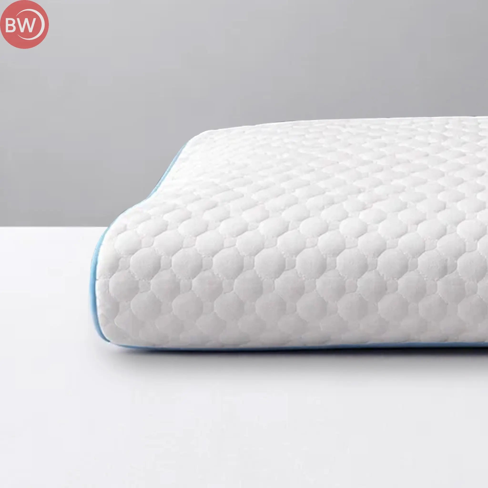 White contoured cooling pillow with quilted honeycomb texture and blue trim