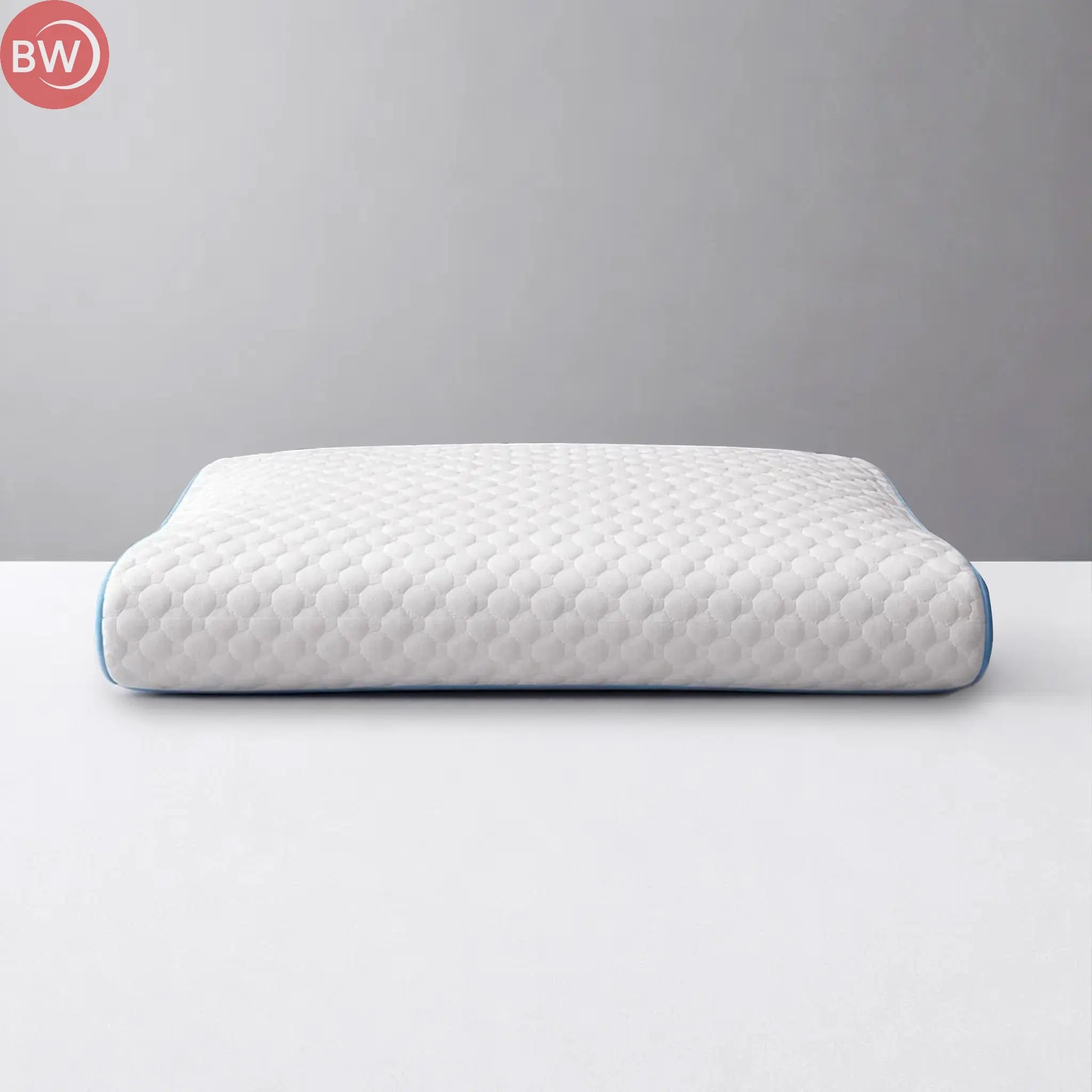 White contoured cooling pillow with blue piping and textured surface, front view