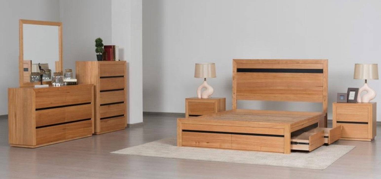 Wooden bedroom furniture set including a bed, dresser, and nightstands in a room.