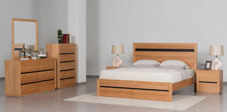 Wooden bedroom furniture set including bed, dresser, and nightstands in a room.