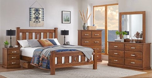 Arizona 7-piece medium brown natural pine wooden bedroom furniture set including a bed frame, nightstands, dresser, chest, and mirror, styled in a bright bedroom with a window showing a sunset view.