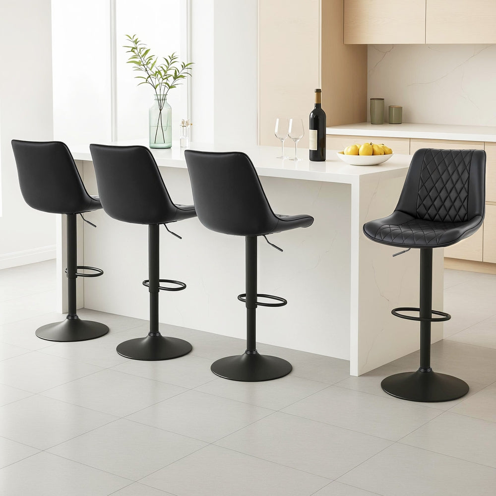 Black diamond-quilted swivel bar stools with cushioned seats and footrests