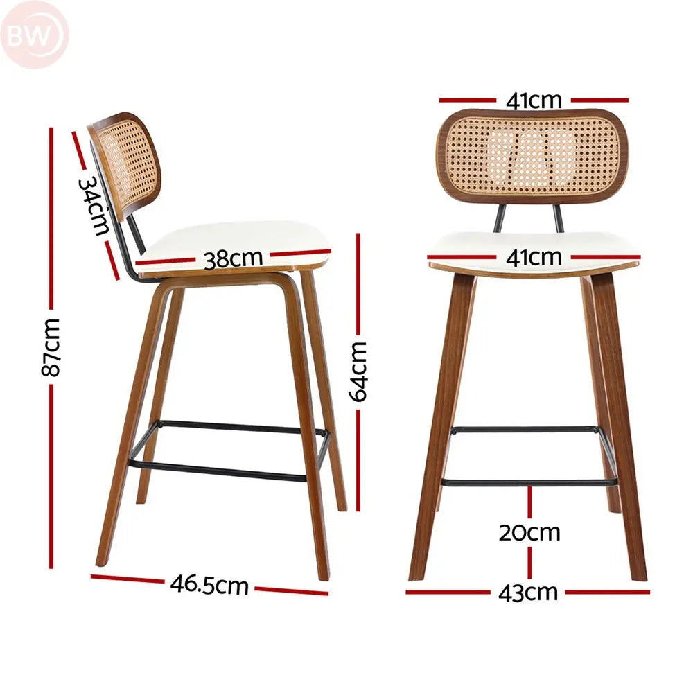 Rattan bar stool with woven back, white seat, and black metal footrest, side view