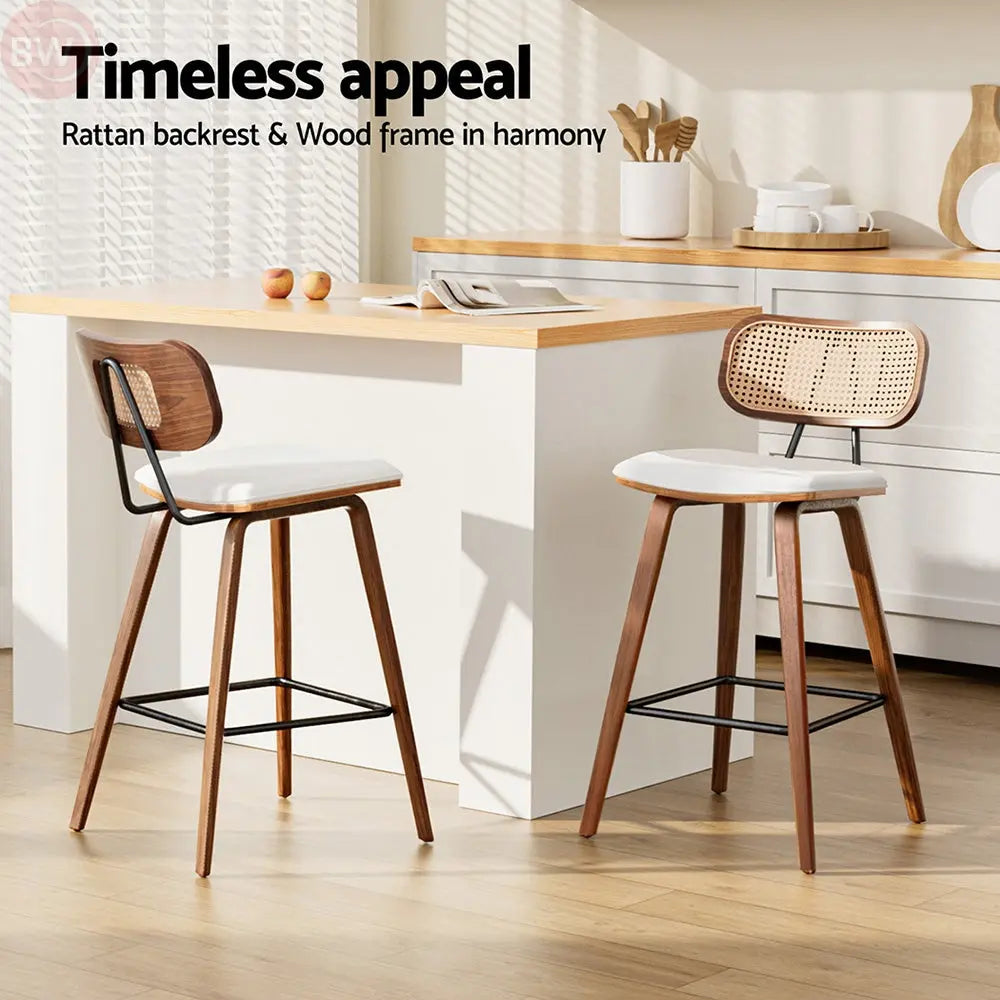 Set of two rattan bar stools with woven backs, white seats, and wooden frames