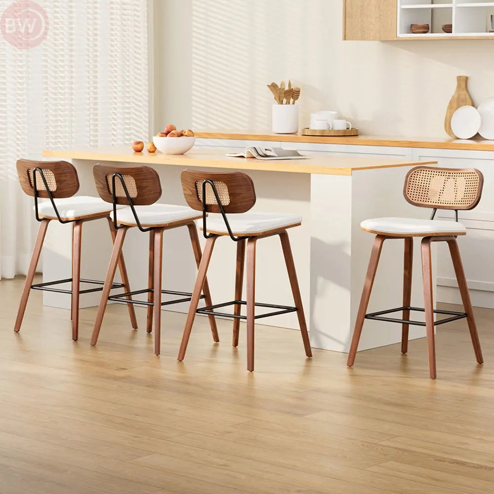 Rattan bar stools with woven dark brown backrests and white cushioned seats