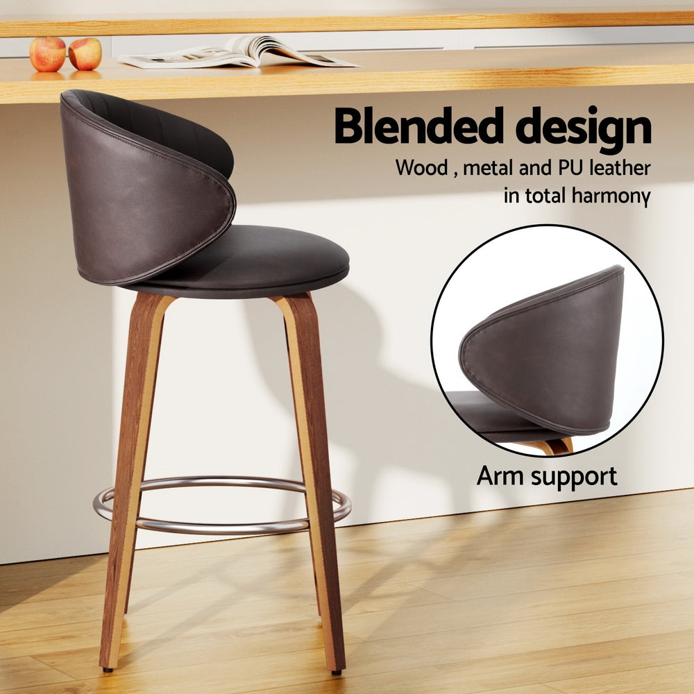 Bar stool with dark brown PU leather look, contoured seat and arm support, chrome footrest