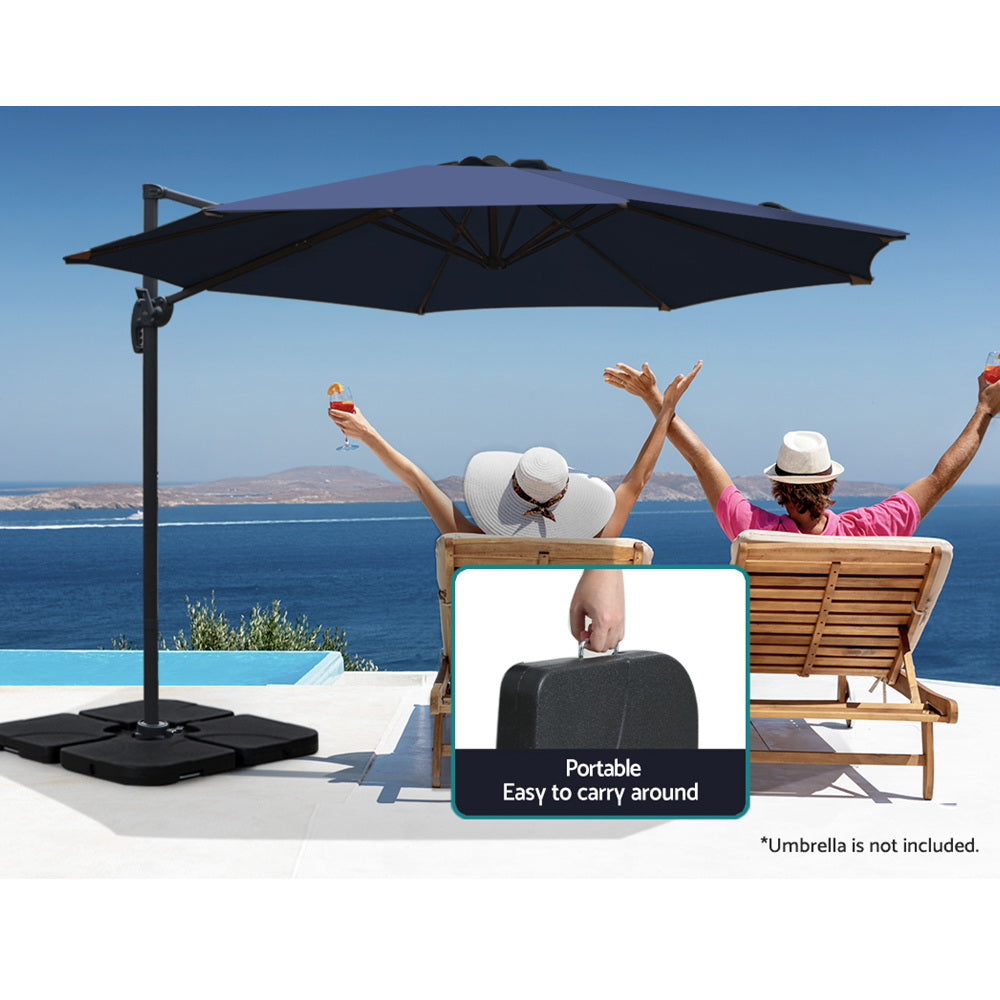 Portable umbrella base with four dark plates and central pole hole