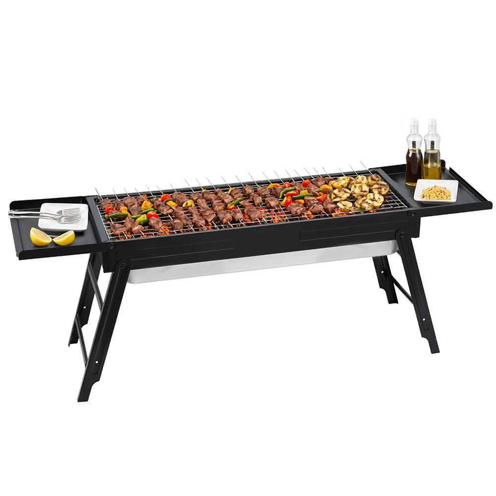 Portable charcoal BBQ grill with foldable legs, side shelf, and cooking grate with skewers