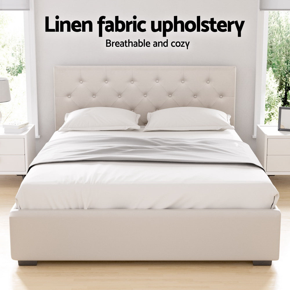 Beige upholstered double bed frame with tufted headboard and fitted fabric mattress