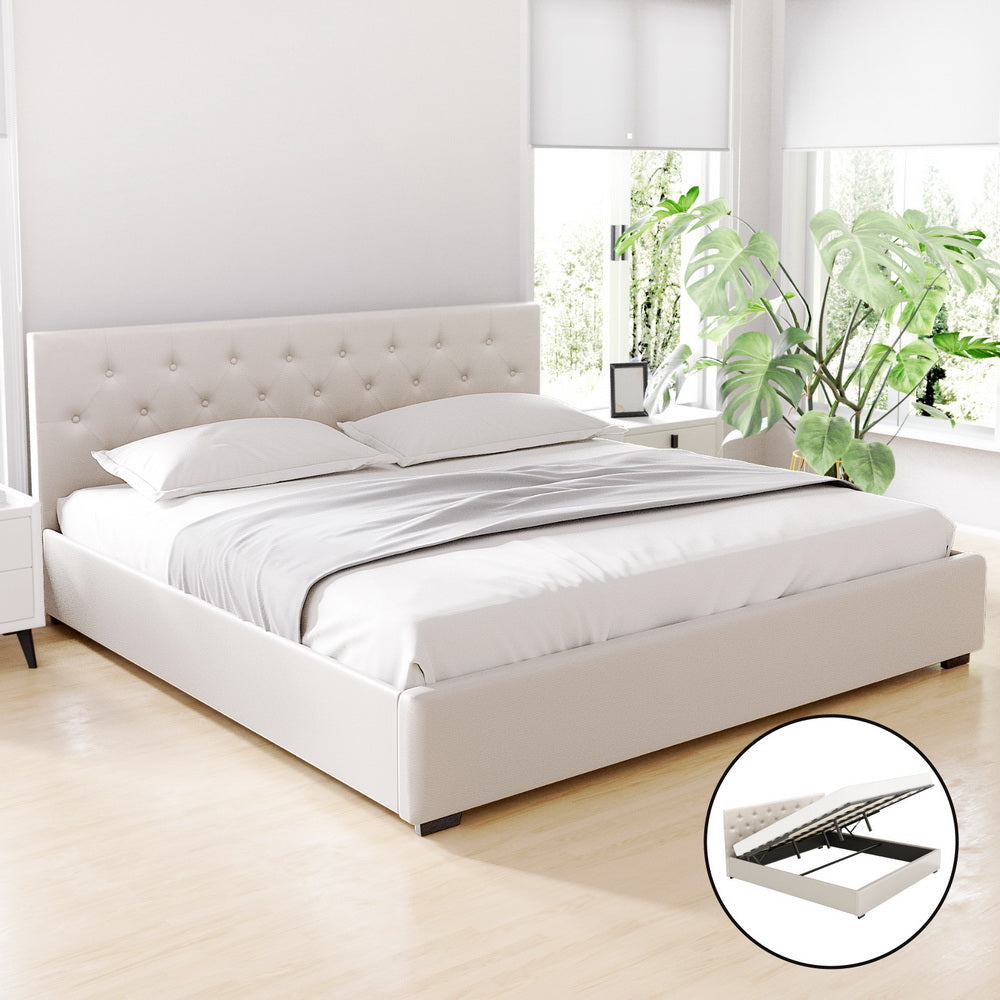 Beige king upholstered bed frame with tufted headboard and lift-up storage base