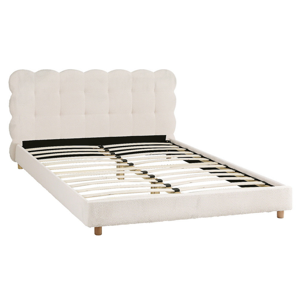 White boucle queen bed frame with tall scalloped cloud headboard and slatted platform
