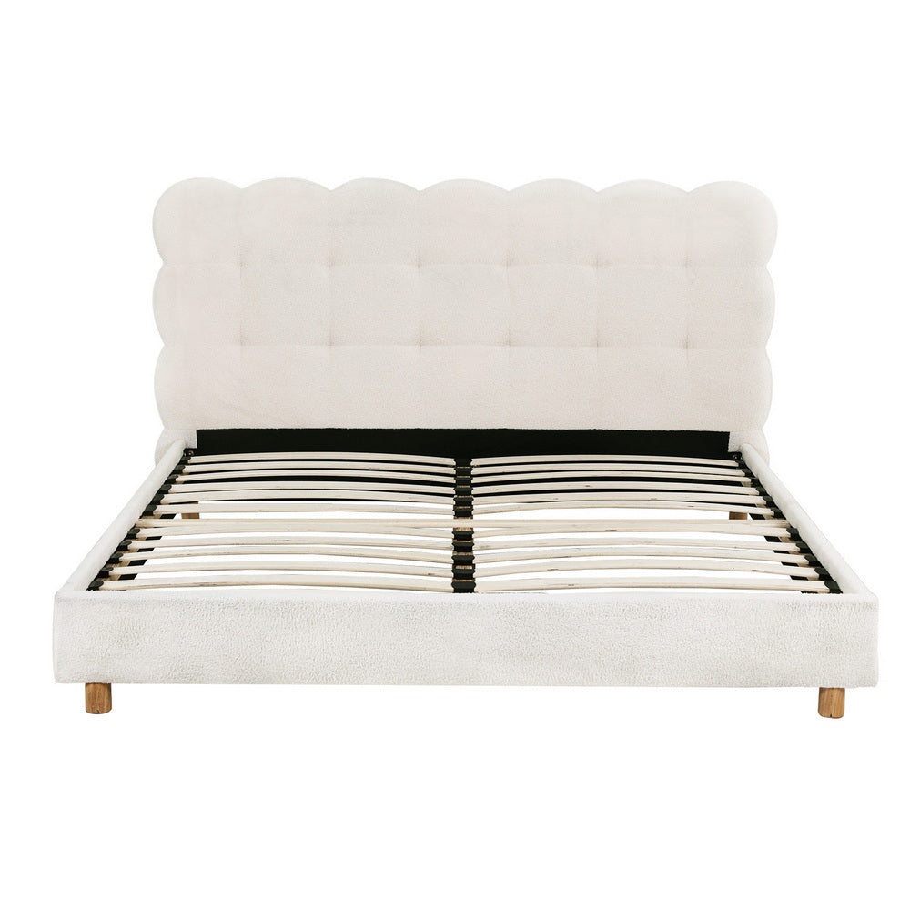White upholstered queen bed frame with cloud headboard and slatted platform base