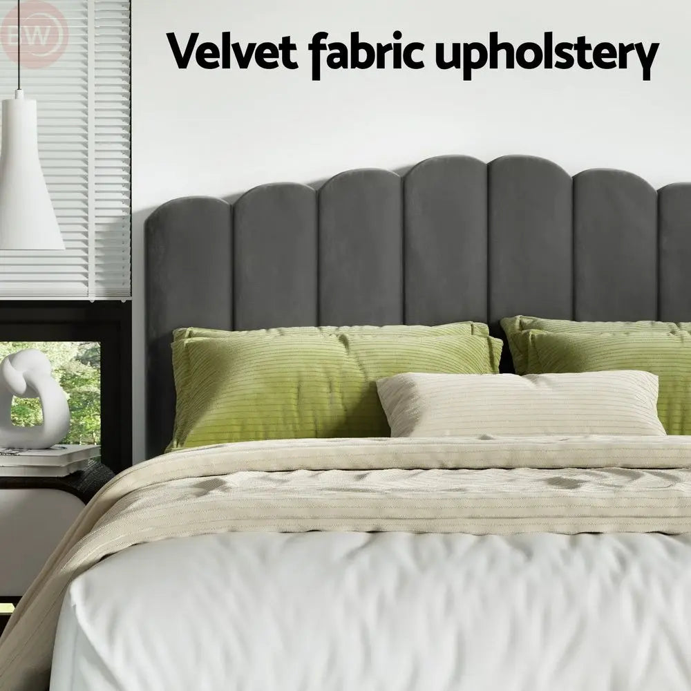 Grey velvet bed frame with tall headboard and cushioned upholstered panels
