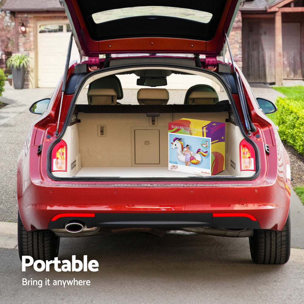 Unicorn inflatable pool float in retail box shown in open car trunk