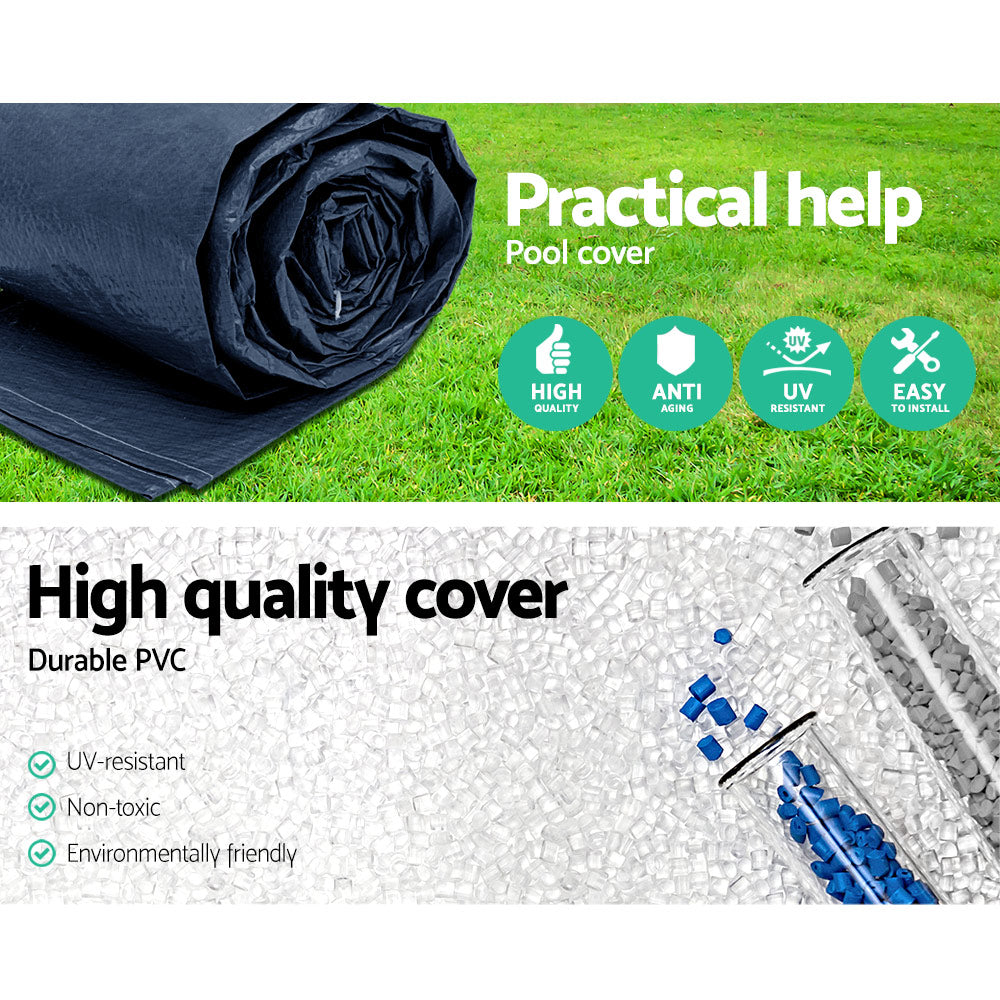 Rolled dark blue PVC pool cover on grass, folded roll close-up