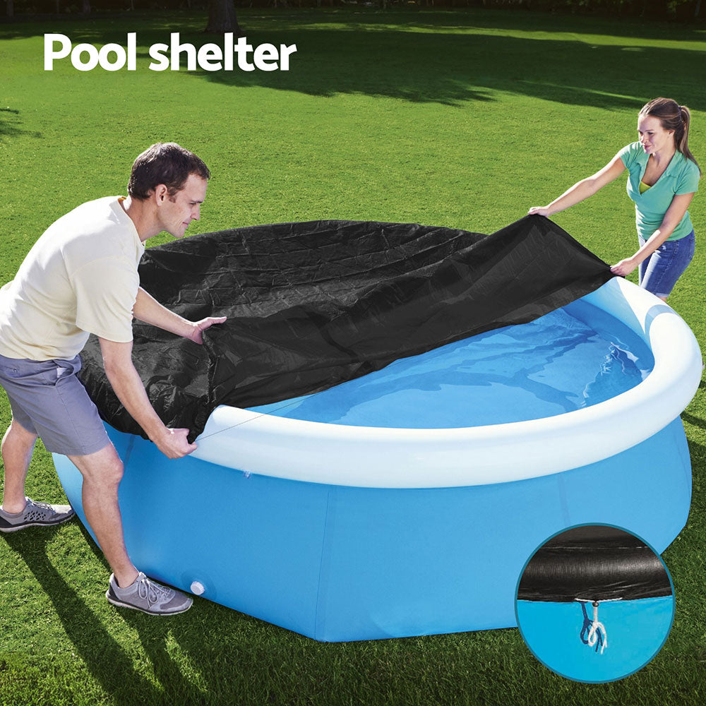 Round black pool cover over a blue above-ground pool