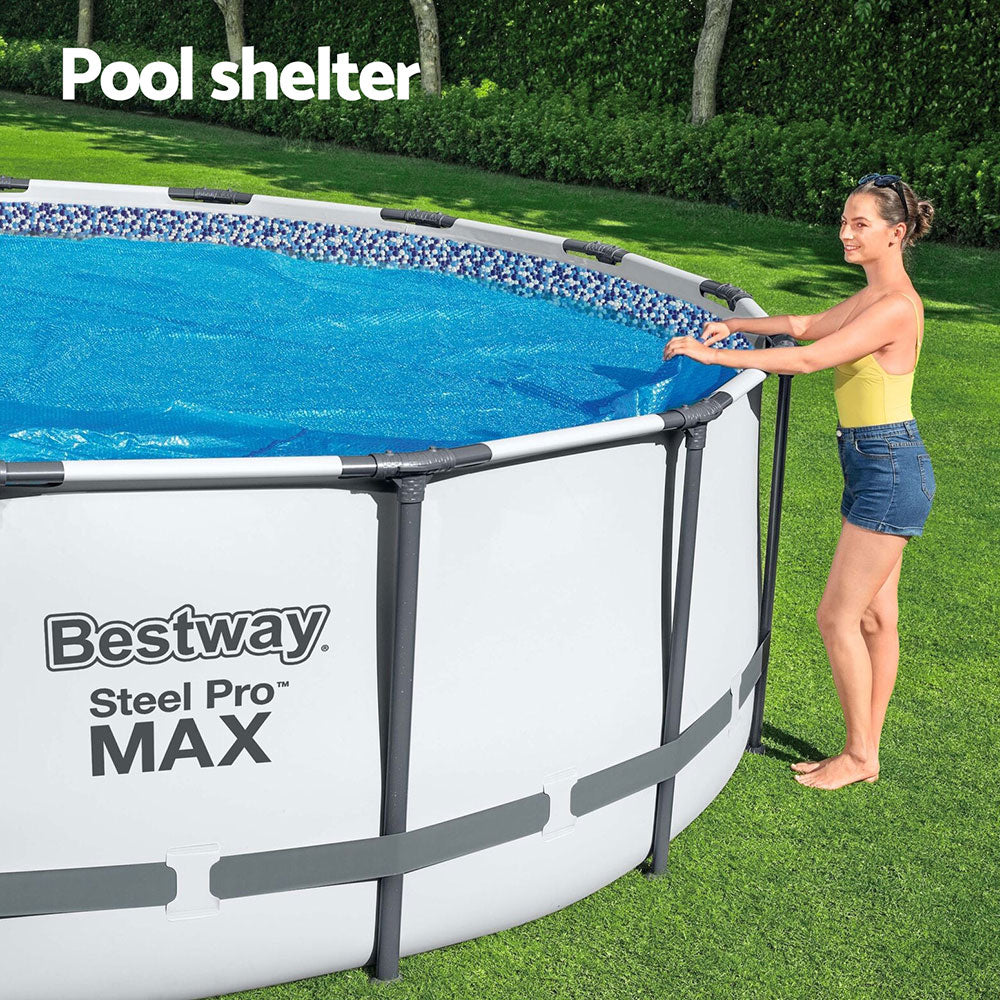 Round solar pool cover on above-ground pool, blue sheet over water surface