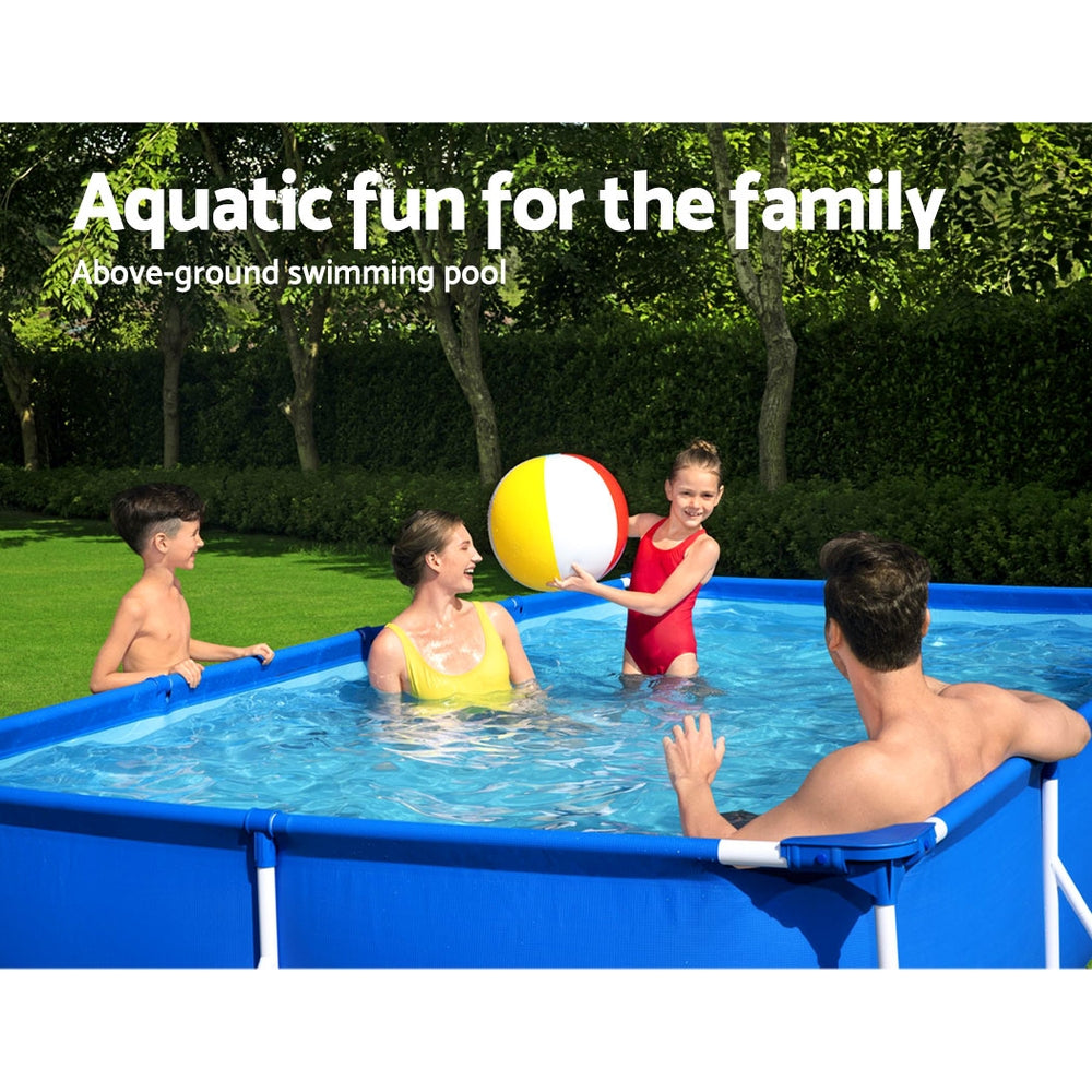 Above-ground swimming pool with blue frame in a garden, family playing in the water