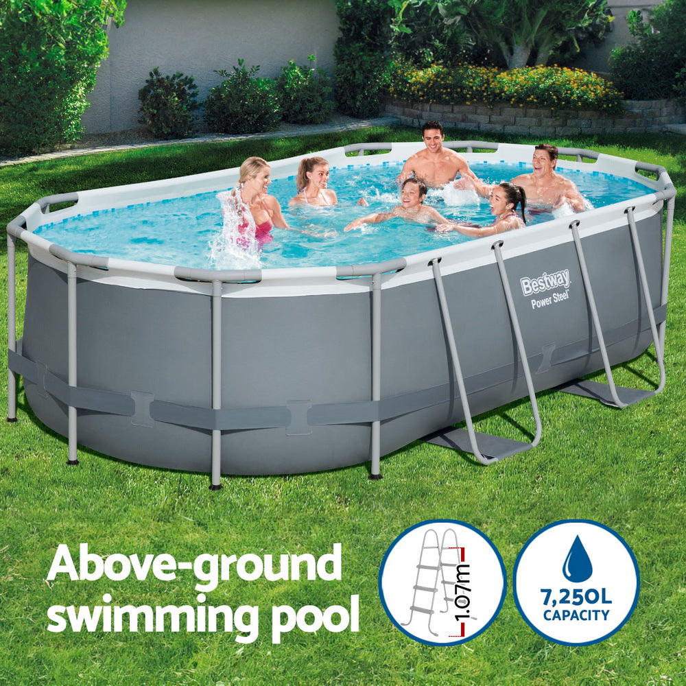 Above-ground swimming pool with gray frame and blue water in a garden