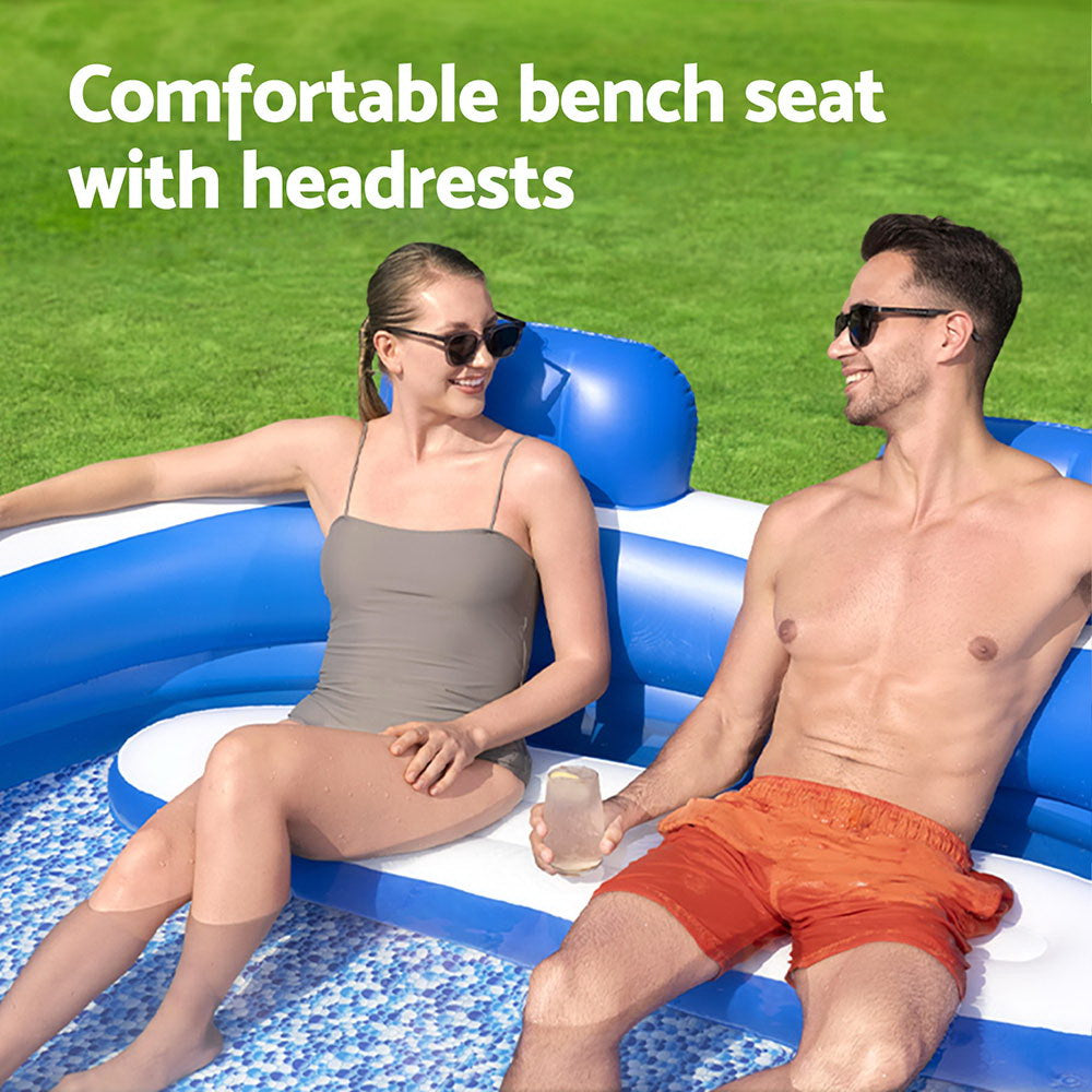 Inflatable kids pool with bench seat and two blue headrests along the rim