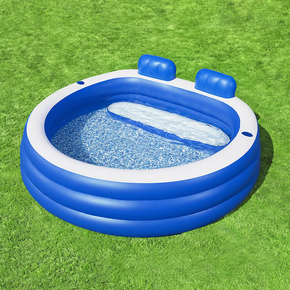 Blue inflatable kids pool with two headrests and speckled blue water inside