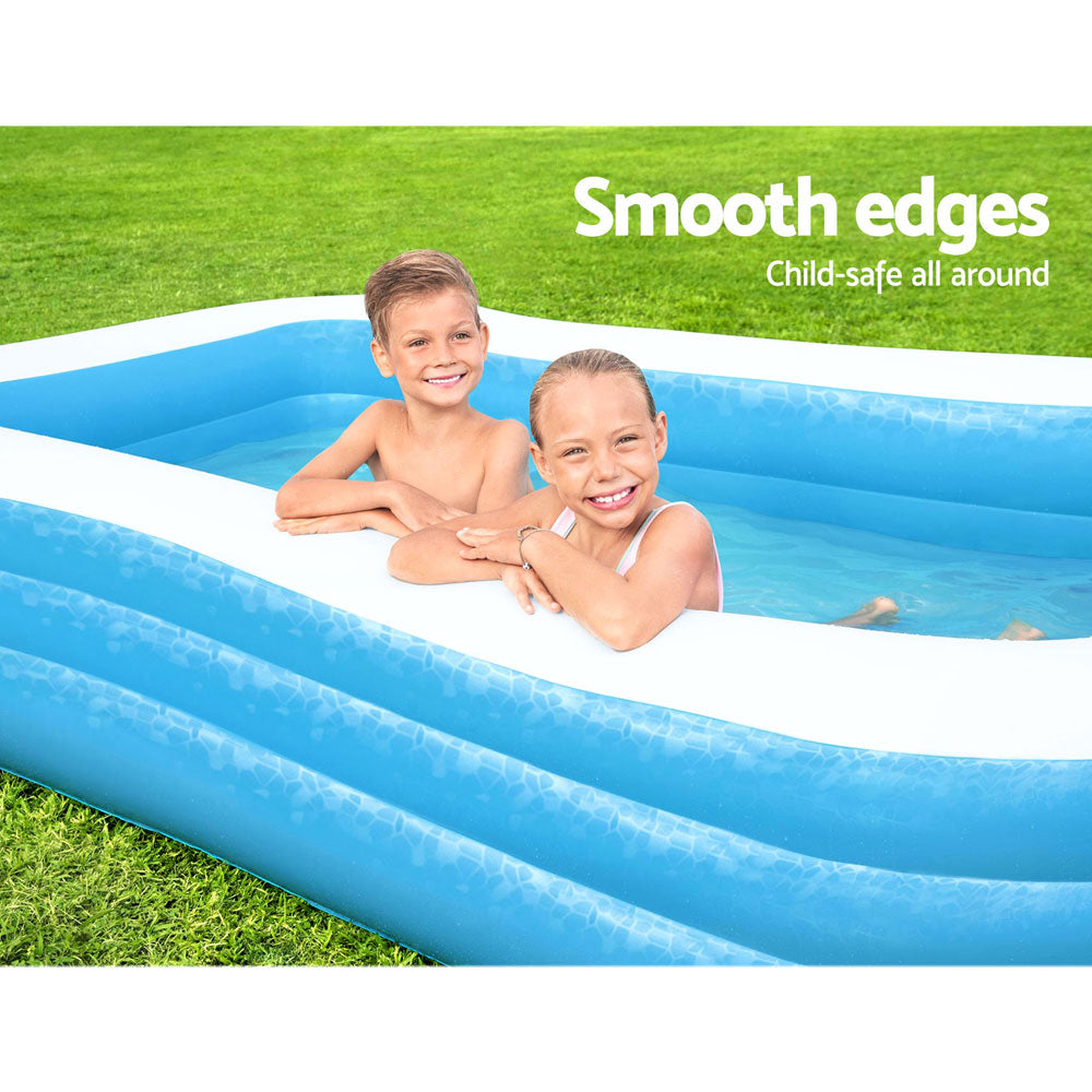 Inflatable rectangular kids pool with blue walls and white rim, with children in the water