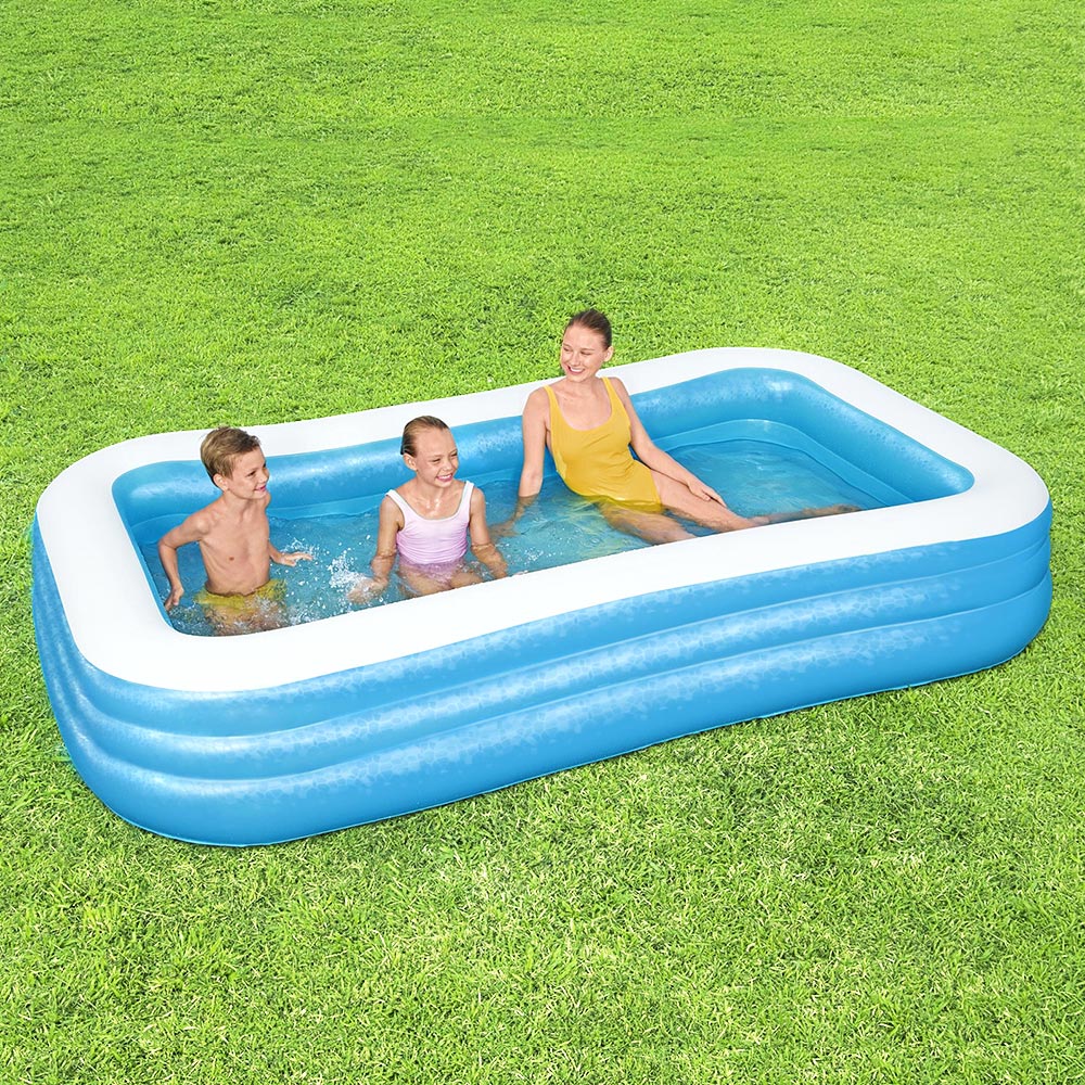 Inflatable rectangular kids pool with blue walls and white rim, with three children inside
