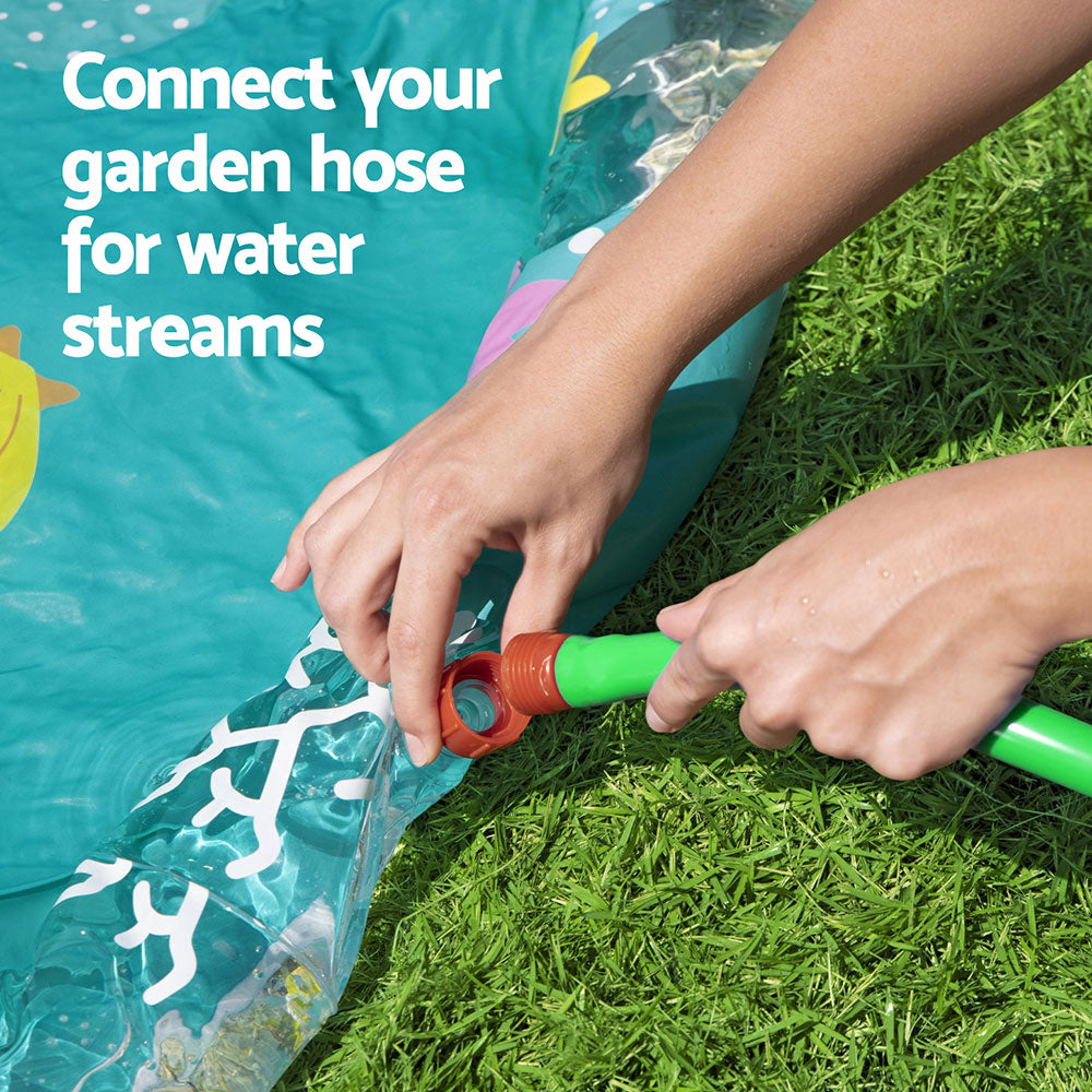 Hands connecting garden hose to teal inflatable splash pool water inlet