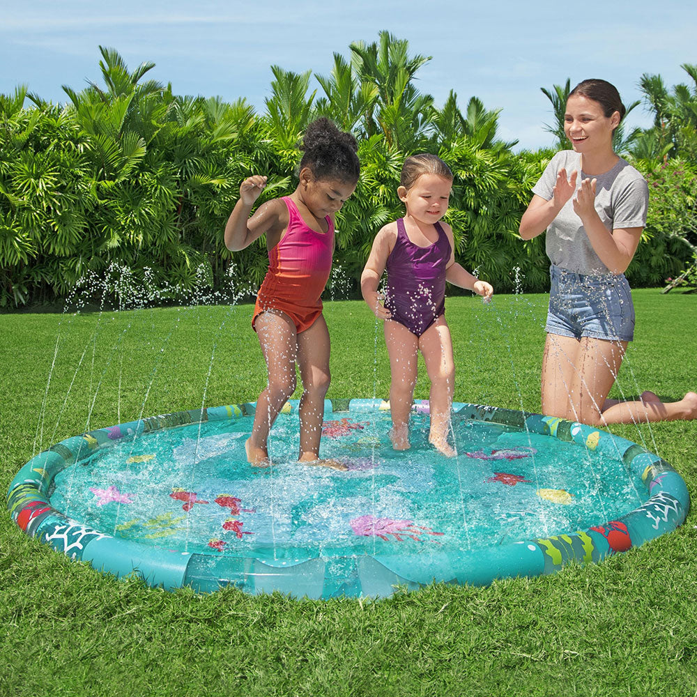 Family playing in a teal round inflatable splash pool with sea creature print