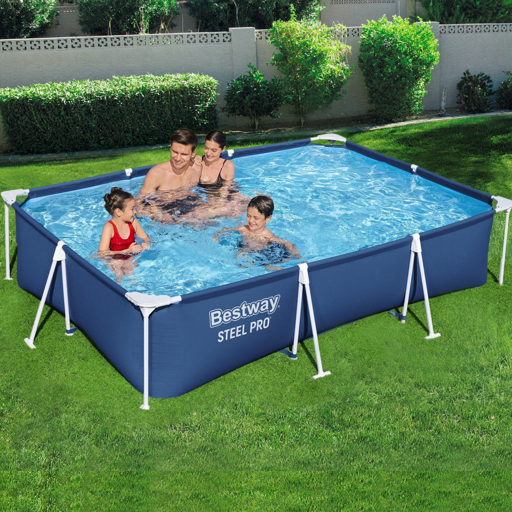 Blue above-ground steel frame swimming pool with people playing in backyard lawn