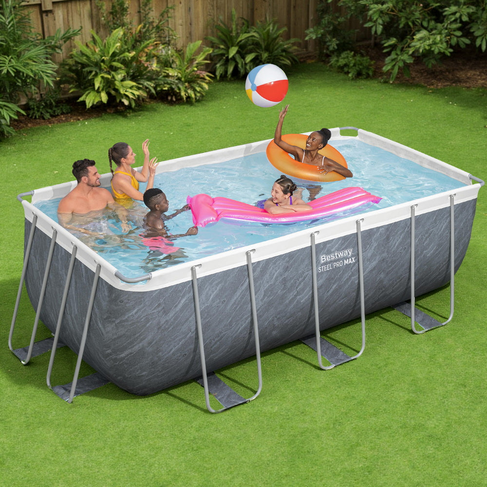Above-ground swimming pool set with gray sidewalls and white rails, shown in a backyard