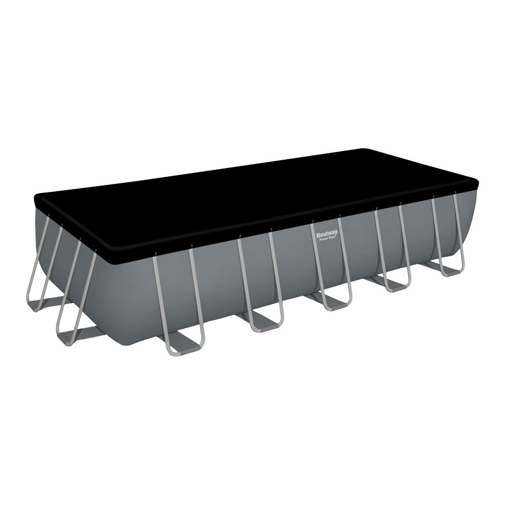 Above-ground swimming pool with black cover and gray steel frame, white top rails