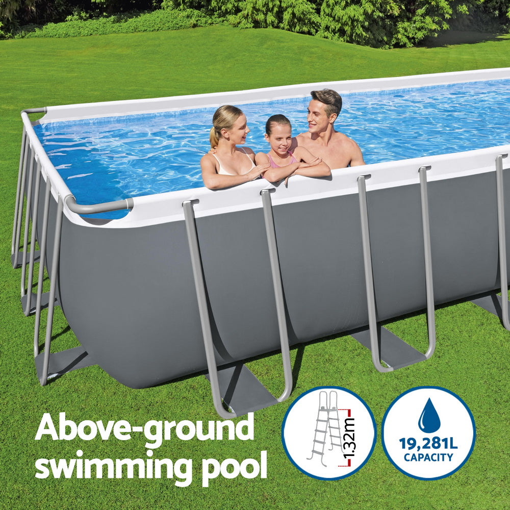 Above-ground swimming pool with blue water and gray steel frame with white top rails