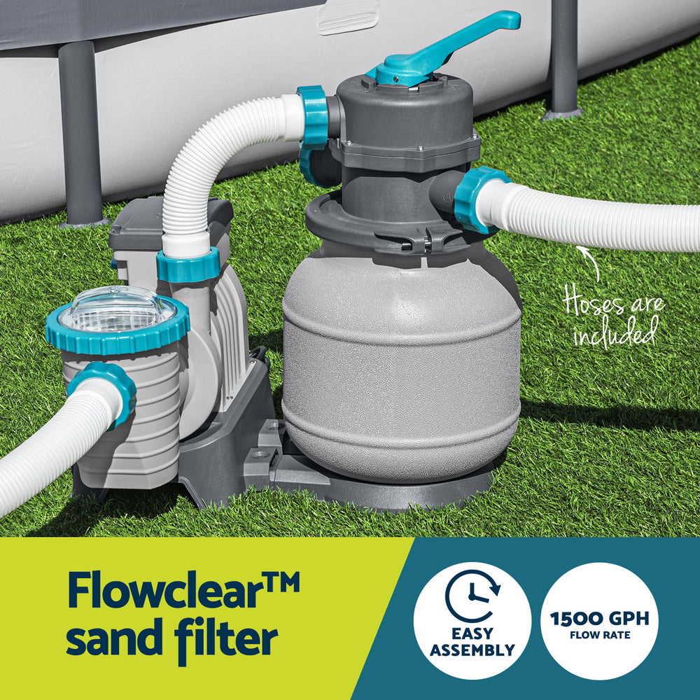 Pool sand filter pump with upright tank and connected white hoses outdoors