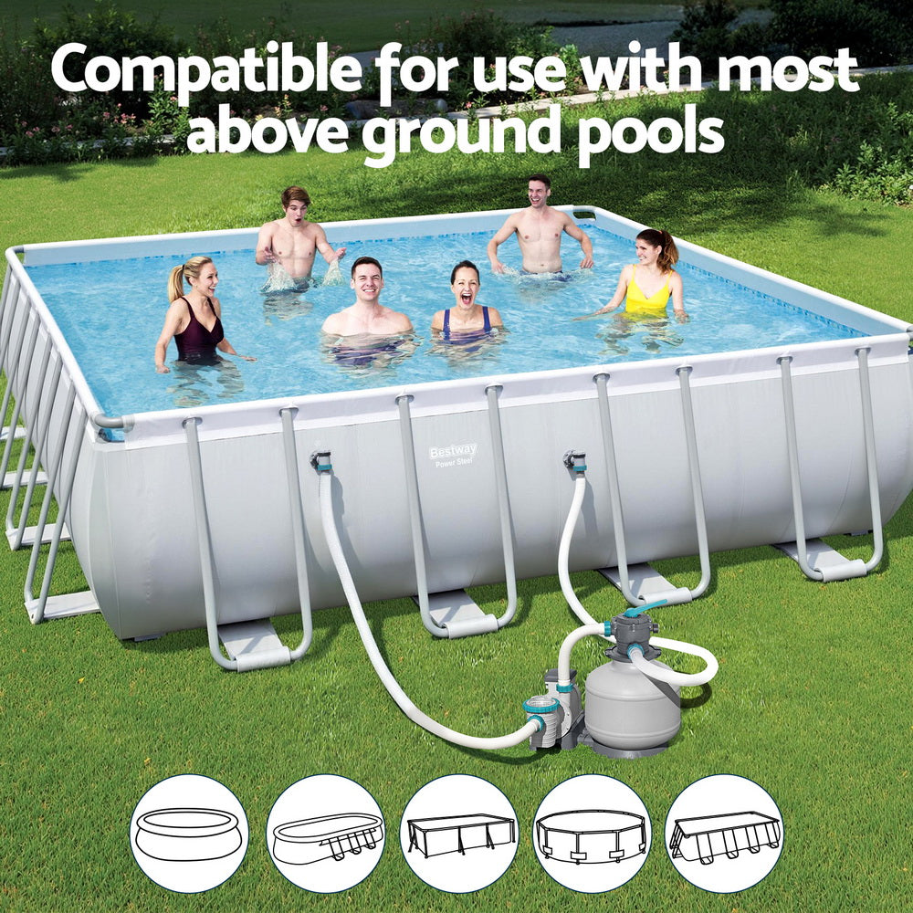 Above-ground pool sand filter pump system connected to a large pool on grass
