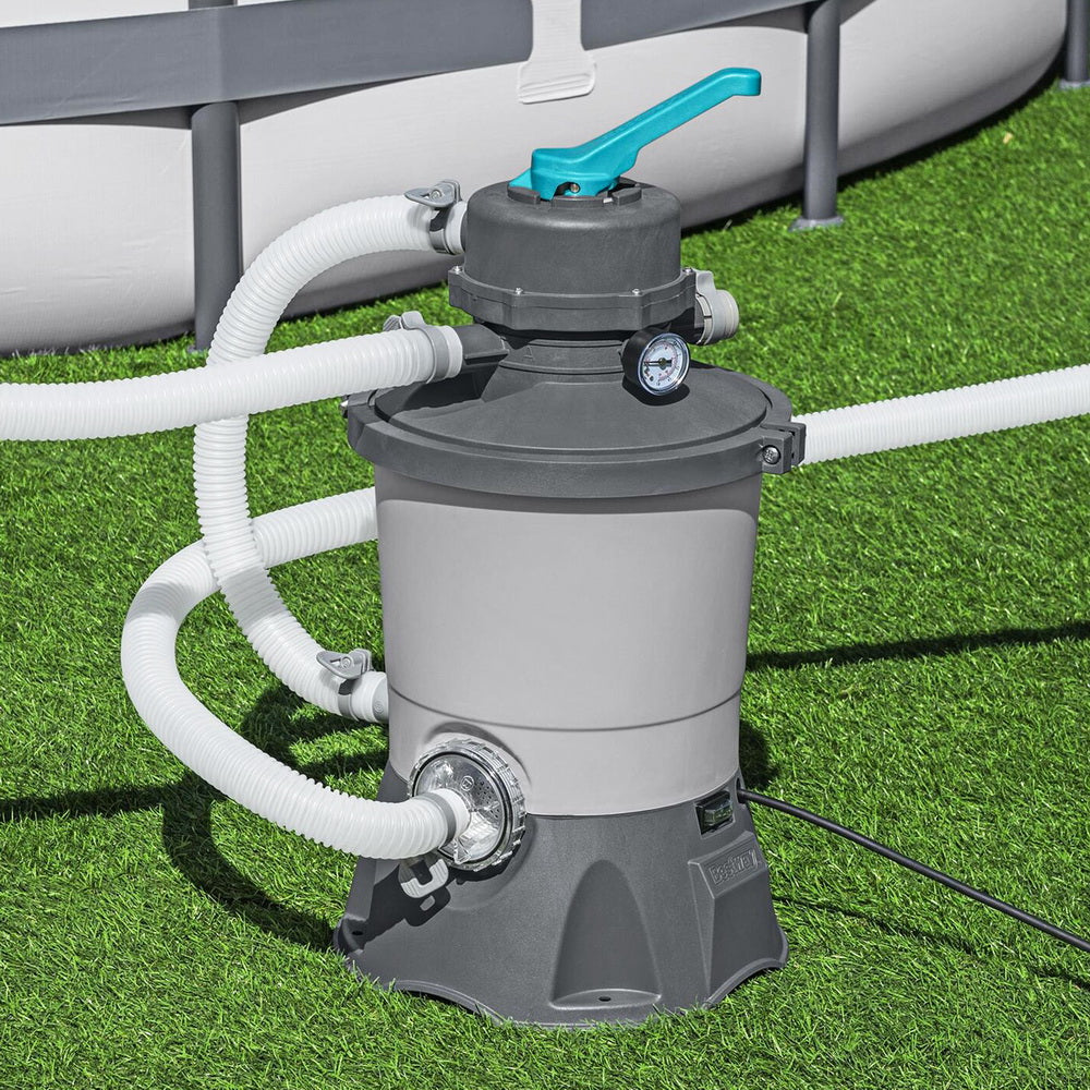Pool sand filter pump with connected white hoses, grey tank, dark base, teal top handle