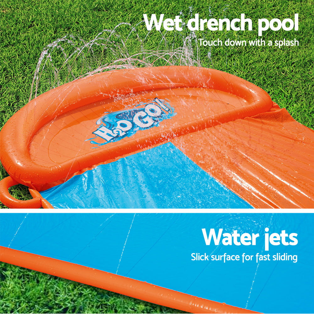 Orange inflatable splash pool with blue slide lane and splash jets, wet surface