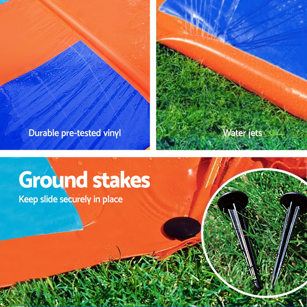 Inflatable water slide with ground stakes and water-jet area on orange base