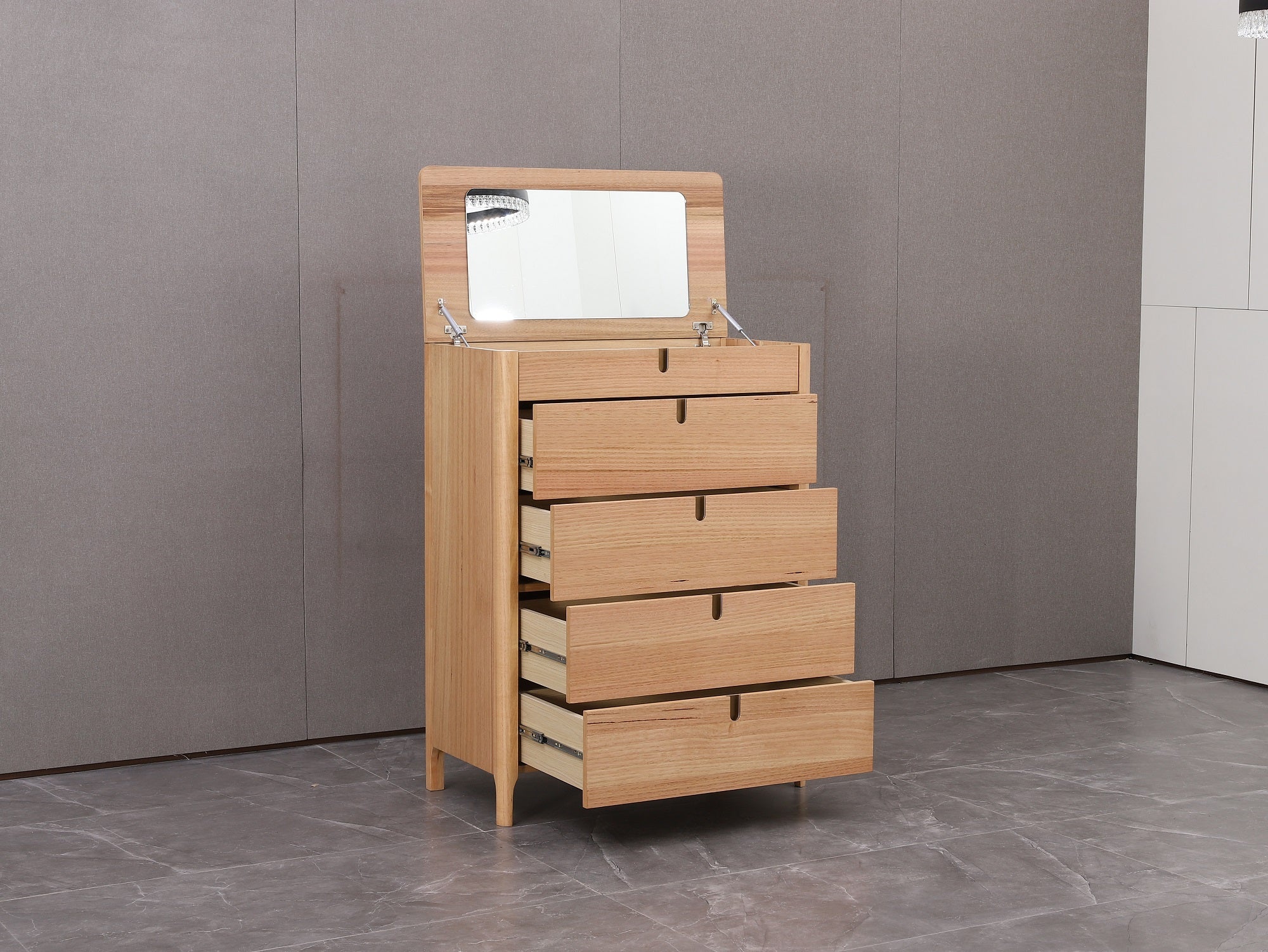 Wooden dresser with mirror on a gray floor against a gray wall