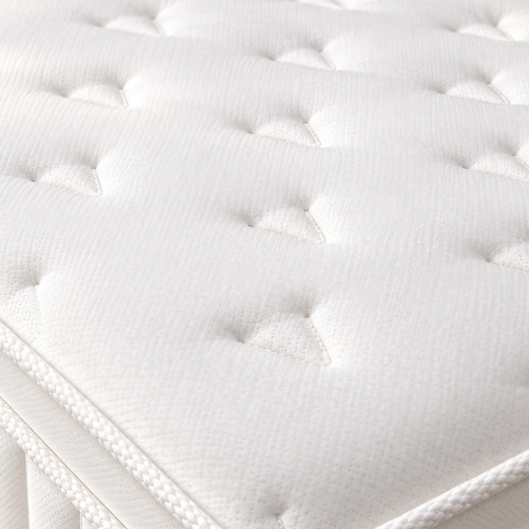 Close-up of breathable knitted fabric cover and quilted pillow top on Loren Williams Ortho Firm+ Mattress
