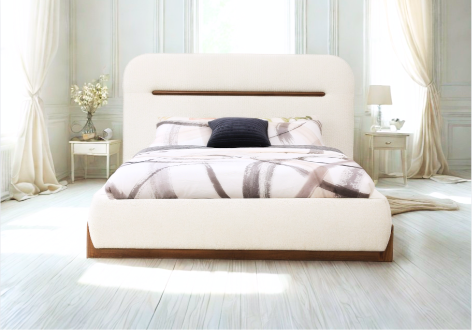 Modern bedroom with a white upholstered bed and decorative pillows.