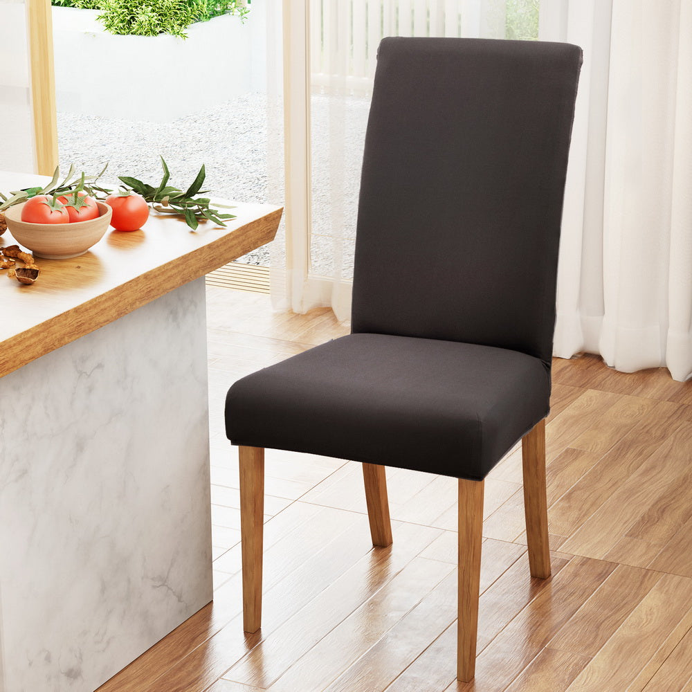 Dark grey high-back dining chair slipcover with fitted seat and open chair legs