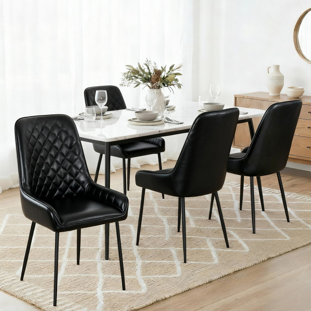 Black quilted PU leather dining chairs with curved backs, arms, and slim metal legs