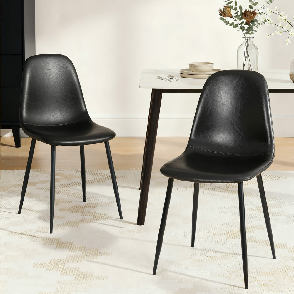 Black dining chair pair with curved backrests and contoured seats, slim metal legs